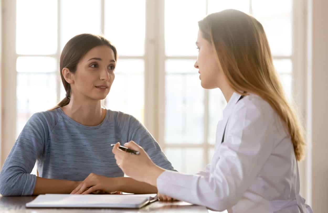 A young woman talks to her doctor about South Jersey relapse prevention services.